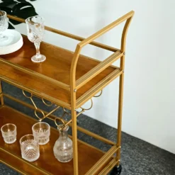 Gold Metal 2-Tier Bar Cart Wine Rack With Wooden Serving Trays, Kitchen Trolley With 5 Wine Bottles & 2 Wine Glass Holder Rack 3ft -Home Decor Promotional Store FURN CART 003 GOLD D08.progressive 63fffc5c 8a80 4cab a6d1 20a86901f26a