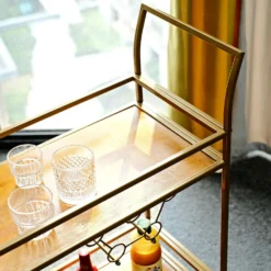 Gold Metal 2-Tier Bar Cart Wine Rack With Wooden Serving Trays, Kitchen Trolley With 5 Wine Bottles & 2 Wine Glass Holder Rack 3ft -Home Decor Promotional Store FURN CART 003 GOLD D11.progressive 66b14bb0 709d 402c b3f1 4b0598de3cc5